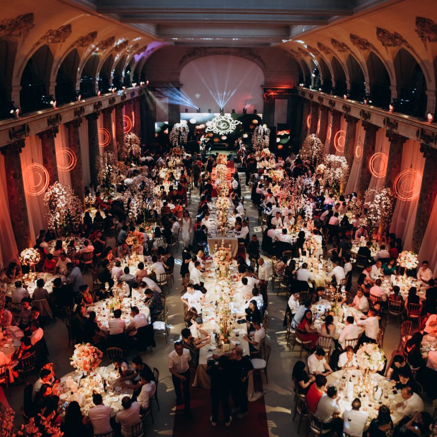 round tables in celebration hall with full of guests